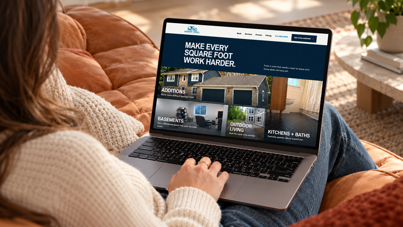 Homeowner browsing a Modern Touch remodeling website on a laptop