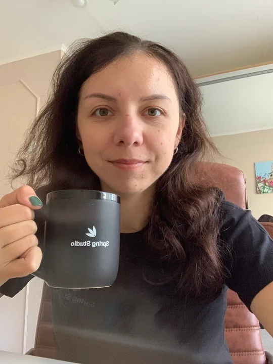 A team member enjoying coffee in a Spring Studio mug